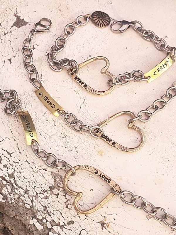 3 unique heart bracelets on distressed table